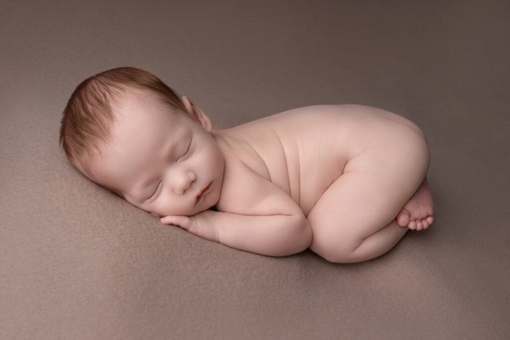Older newborn sleeping on beanbag