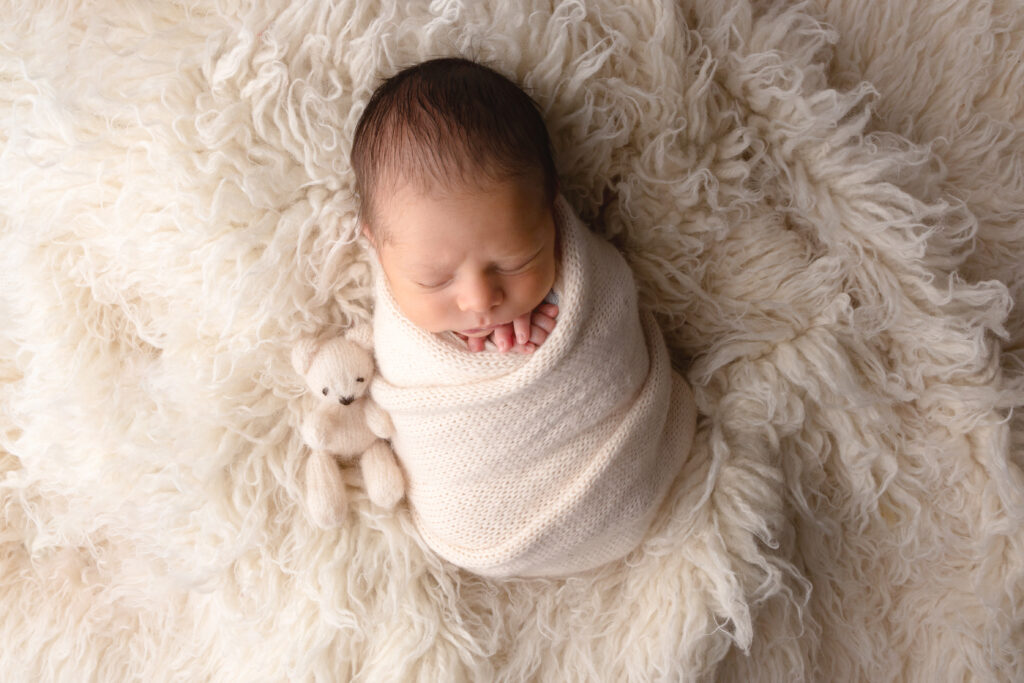 Glasgow Newborn Session with baby wrapped in cream wrap on fluffy blanket
