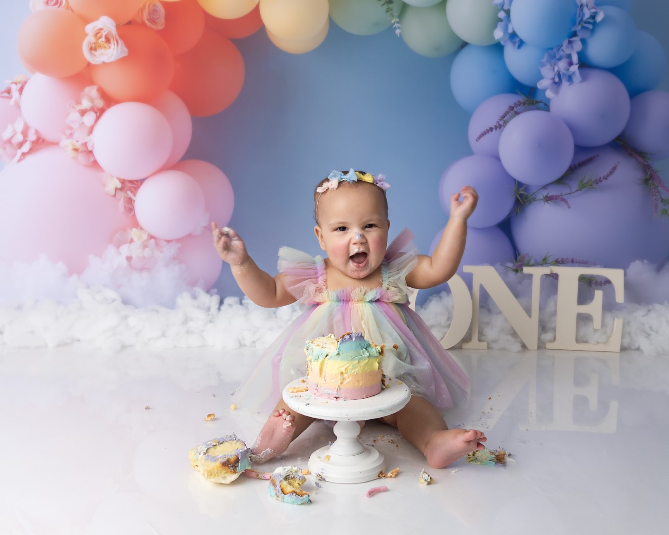 cake smash session with rainbow theme setup